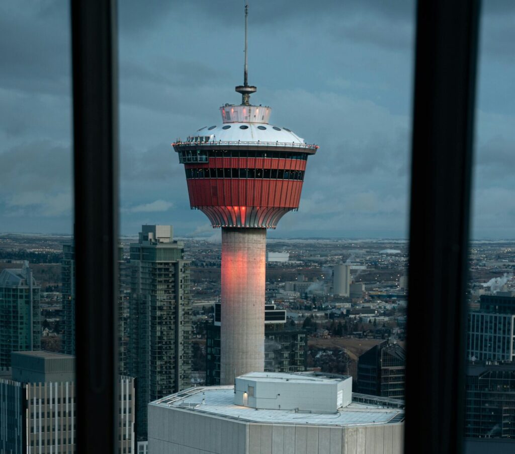 A beautiful view of the Calgary Tower seen through a restaurant window during dusk.